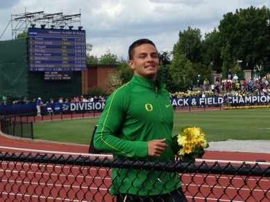 Devon Allen smiles during his victory lap after winning the national title in the men's 110 hurdles.