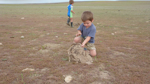 A young Jason Hansen works on his technique while his little brother tees it up